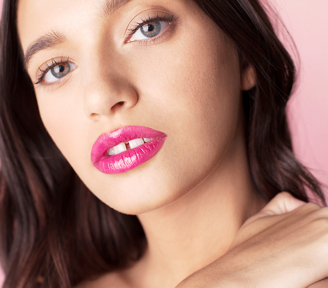 Photograph of a model with pink lipstick applied