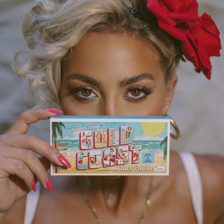 Photograph of Gold Coast Face Palette packaging being held by a model. 