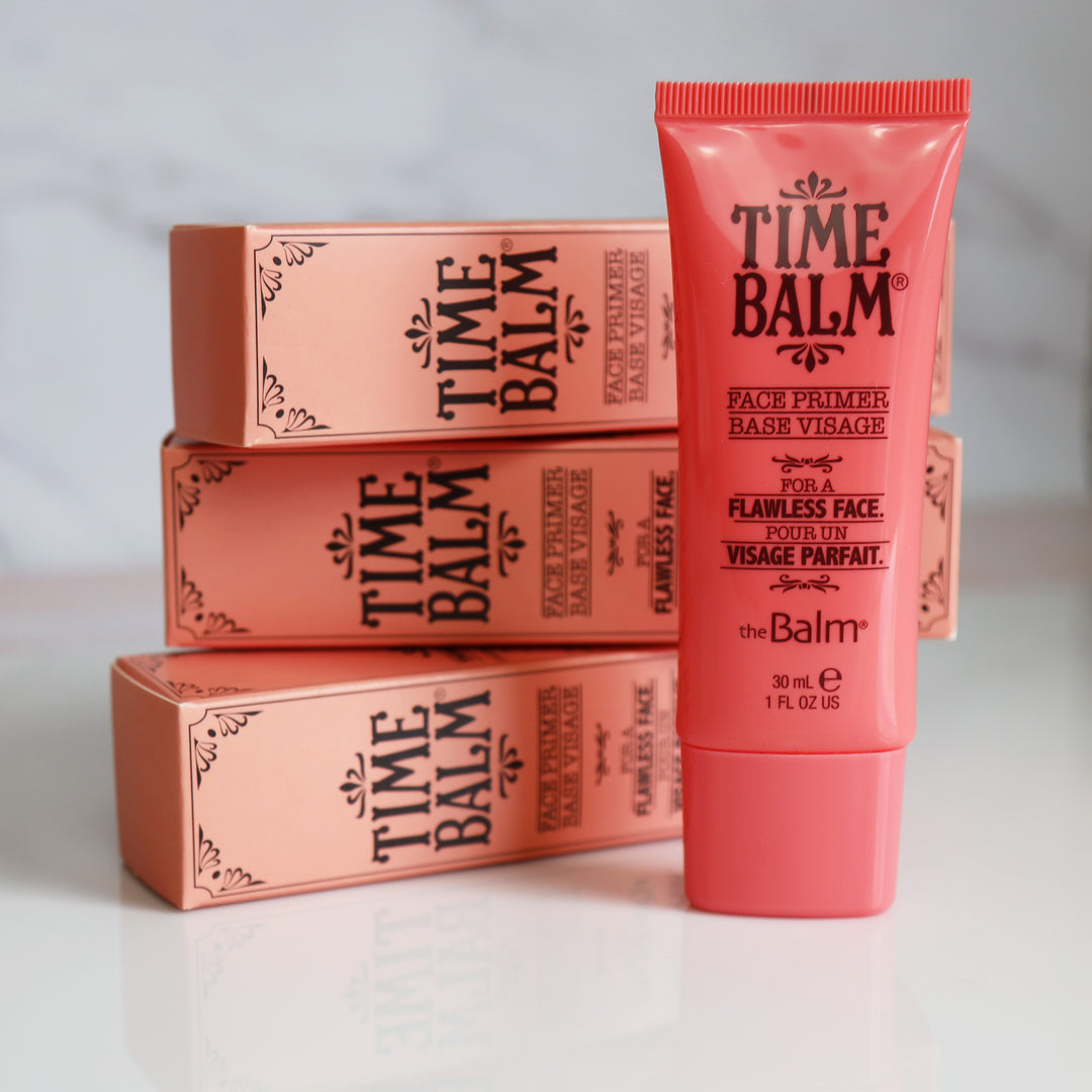 Photograph showing three TimeBalm Primer packages and a makeup tube